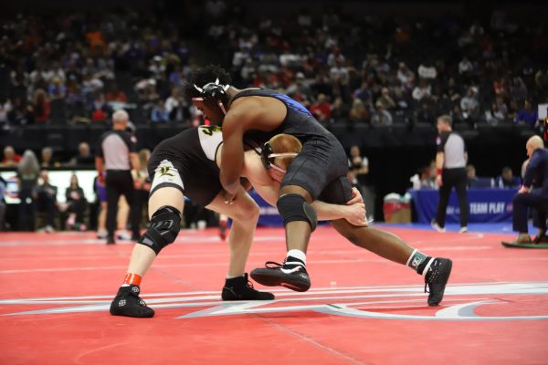 During his semifinal match, senior Carter Welsh (175) grabs the leg of his opponent, senior Donovan Hodges of Liberty, Saturday, Feb. 28. Welsh's win earned him a spot to compete in the state final match. "My favorite part of the weekend was after my semifinal match: celebrating with my coaches, my family, and my teammates. Sharing that moment with the people who have supported me all season made it even better," Welsh said.