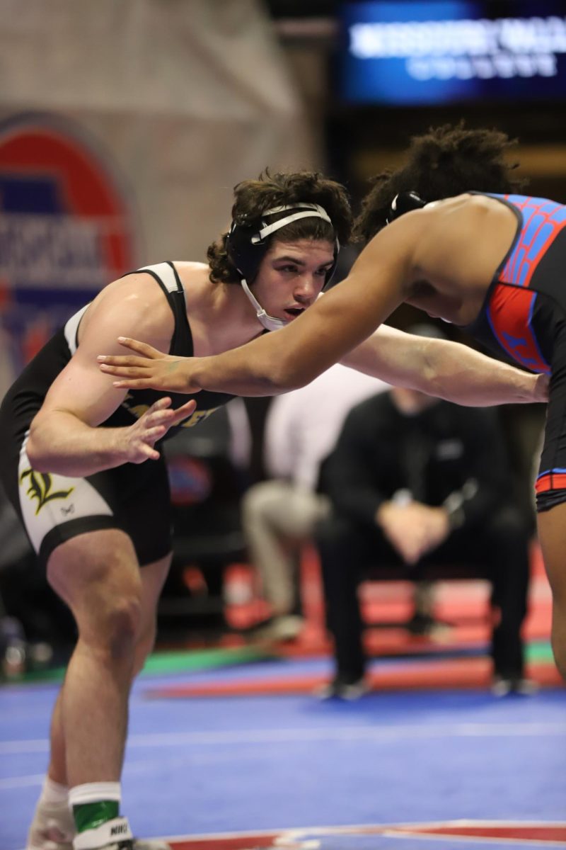 Preparing to lock arms, junior Carter Brown fixes his eyes on his opponent. Brown won by a 7-0 decision over senior Maddox Jones of Liberty High School (Wentzville). 