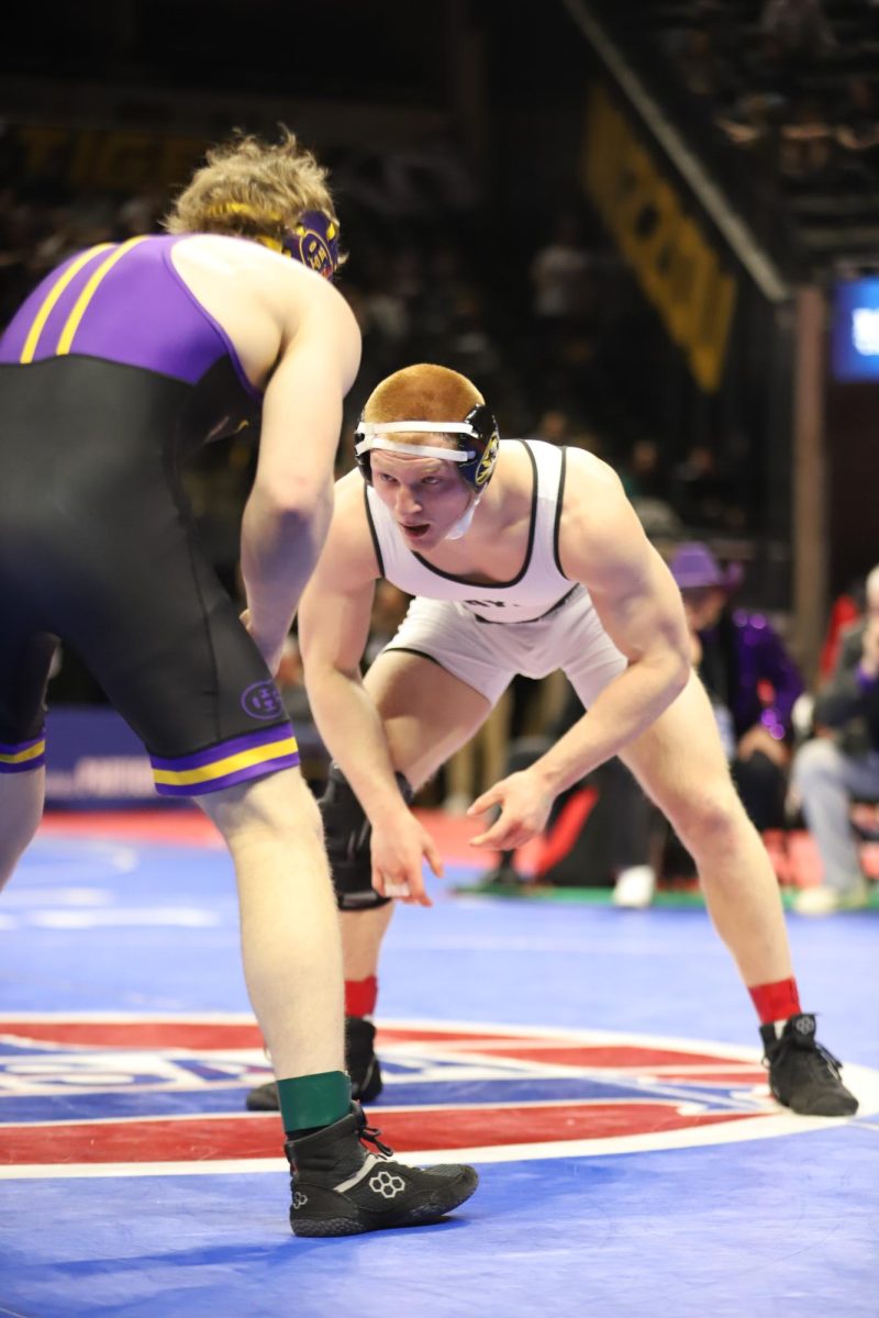 During his bout against junior Luke Hayden of Hickman High School, senior Carter Welsh (175) analyzes his opponent as he circles. "My mindset going into the finals match was just being grateful to be there, especially knowing it was going to be my last time competing at state," Welsh said.
