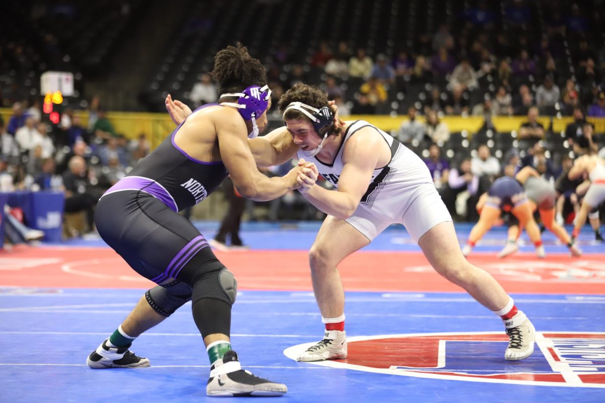 In the boys Class 4 state championship for the 215 weight class, junior Carter Brown launches an attack on his opponent. Brown secured his second straight state title at the 215 weight class with a win by fall.