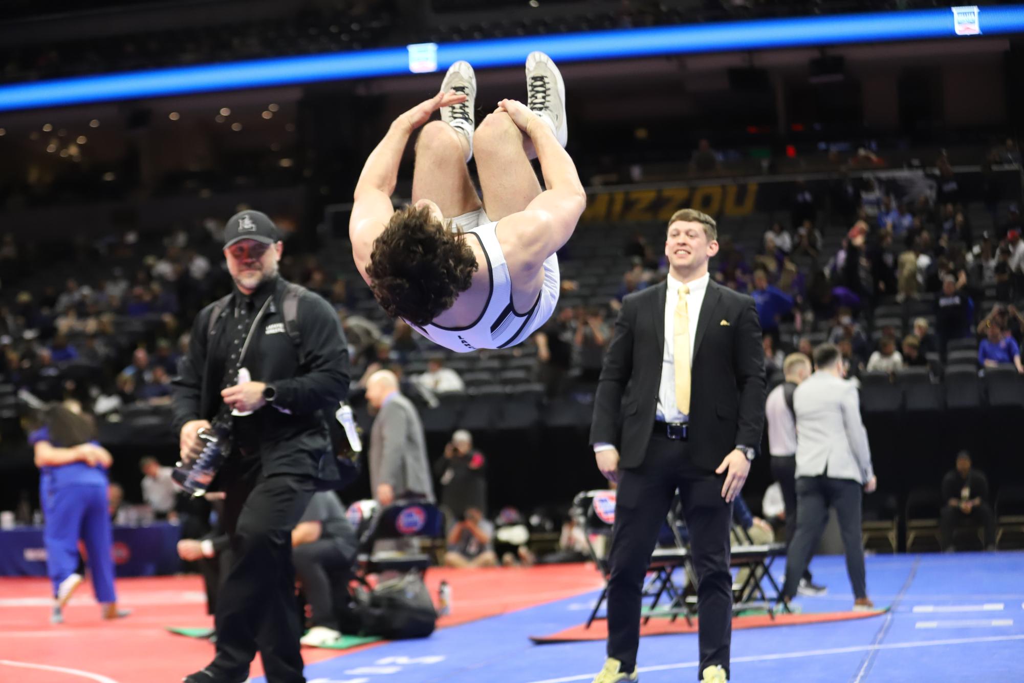 In celebration of winning his second straight state title in the 215 weight class, junior Carter Brown backflips before leaving the mat. Brown won his bout against junior Kobe Rhymes of North Kansas City High School by fall in just 41 seconds. "Carter does what Carter does. We expect [success] out of him and his goals are bigger than the state championship," coach Sam Ritchie said.