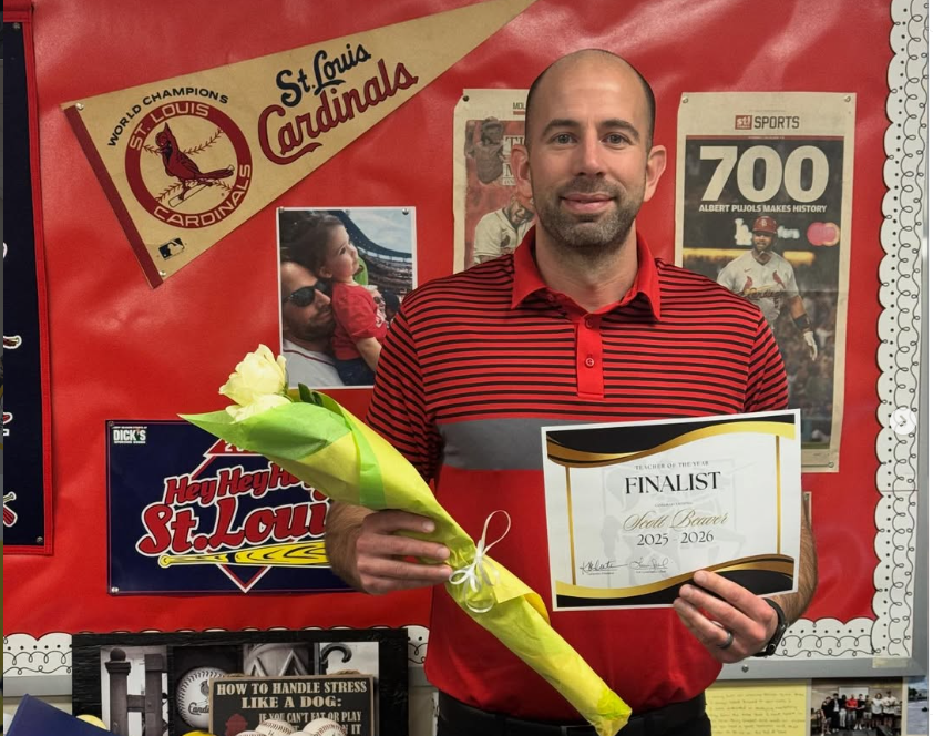 In a photo by principal Karen Calcaterra,  business teacher Scott Beaver stands holding his Teacher of the Year nomination. (lhs_principal/Instagram)